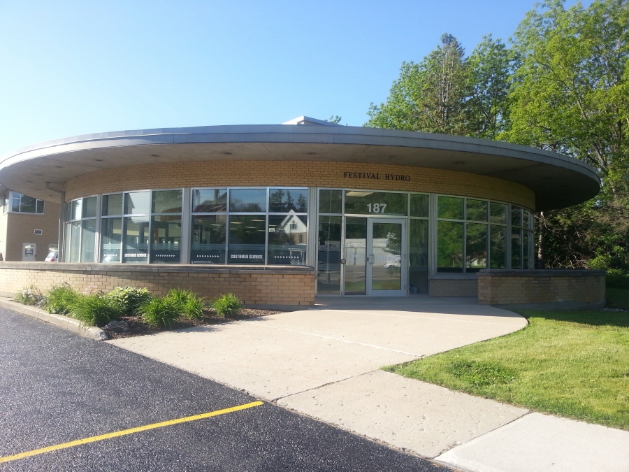 The Festival Hydro building's front entrance is a rounded front with double entrance doors labelled customer servcie entrance.